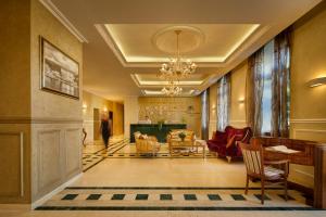 a hallway with a living room with a chandelier at BO Hotel Palazzo in Poreč