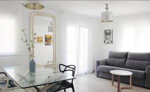 a living room with a glass table and a couch at Olivia Apartments TRG in Benidorm
