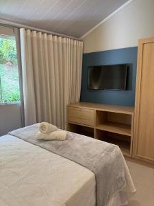 Cama ou camas em um quarto em Hospedaria Aconchego
