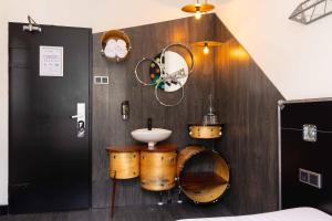 a bathroom with a sink and drums on the wall at Backstage Hotel Amsterdam in Amsterdam