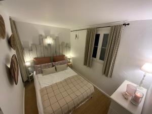 a small bedroom with a bed and a window at Les Restanques du Golfe de Saint Tropez Außergewöhnlicher Meerblick TOP WLAN in Grimaud +72 photos