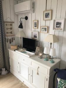a white cabinet with two lamps on top of it at Les Restanques du Golfe de Saint Tropez Außergewöhnlicher Meerblick TOP WLAN in Grimaud