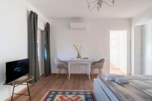 a bedroom with a bed and a table with chairs at La terrazza sul Ricetto - Appartamento Suite in Candelo