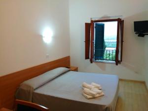 En eller flere senge i et værelse på IL CASALE B&B