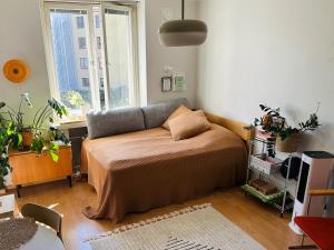 a bedroom with a bed and a window at Cozy studio apartment with amazing location in Helsinki