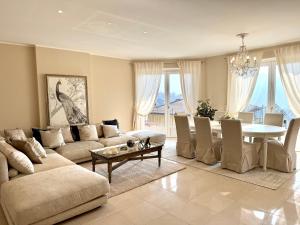 a living room with a table and a dining room at Villa Charme in Tremezzo