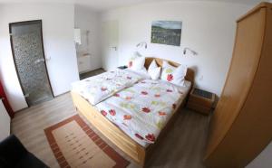 a bedroom with a bed with a floral comforter at Haus Budinger in Alf