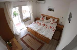 a bedroom with a bed with red roses on it at Haus Budinger in Alf