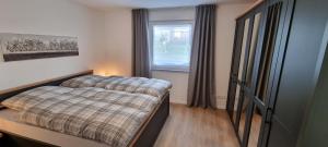 a small bedroom with a bed and a window at Ferienhaus Knoke Ii in Marienmünster