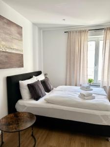 a bedroom with a large bed and a window at Spiritus Apartments in Augsburg