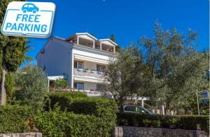 a building with a free parking sign in front of it at Ivan&Anka Selce apartments in Selce