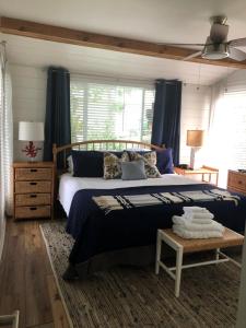 Un dormitorio con una cama grande y cortinas azules. en Lakefront with Dock on Private Lake Florence near Montverde Academy, en Montverde