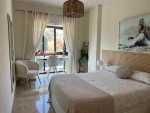a bedroom with a large bed and a dining room at Puerto De La Duquesa in Manilva +44 photos