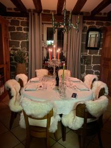 a dining room with a table with chairs and candles at Chambre avec du charme in Saint-Martin-sous-Vigouroux