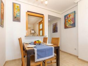 a dining room with a table and chairs and a mirror at Apartment Jardines del Mar I-1 by Interhome in El Borseral