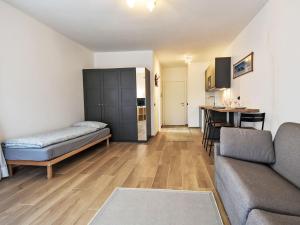 a living room with a couch and a table at Studio San Anton by Interhome in Bormio