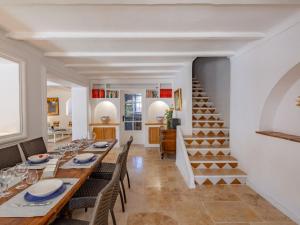 a dining room with a table and chairs and a staircase at Holiday Home Villa Cyrnos by Interhome in Sainte-Maxime