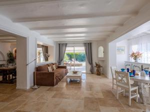 a living room with a couch and a table at Holiday Home Villa Cyrnos by Interhome in Sainte-Maxime +29 photos