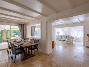a dining room with a wooden table and chairs at Holiday Home Villa Cyrnos by Interhome in Sainte-Maxime
