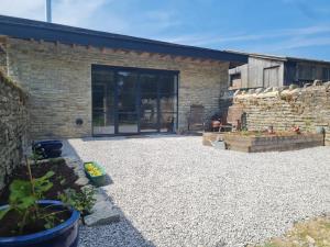 a stone patio in front of a brick building at The Potting Shed in Glastonbury