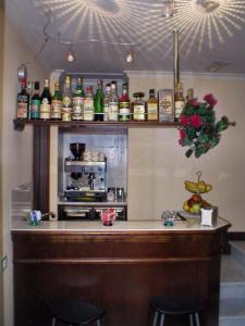 a kitchen with a bar with two stools and a microwave at Soggiorno Angelus in Rome