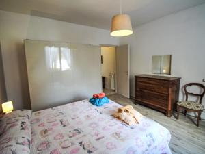 a bedroom with a bed with two dogs laying on it at Apartment Roberto by Interhome in Mergozzo +20 photos
