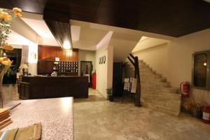 a living room with a staircase and a kitchen at Hotel Platon in Faliraki