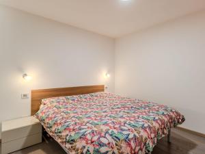 a bedroom with a bed with a colorful bedspread at Apartment Elisa by Interhome in Ronzone