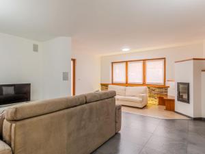 a living room with a couch and a fireplace at Apartment Elisa by Interhome in Ronzone