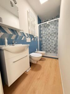 a bathroom with a sink and a toilet and a shower at Ella vacanze in Grottammare