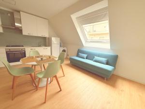 a living room with a table and a blue couch at Ella vacanze in Grottammare