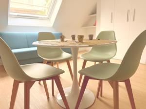 a table and chairs with cups on top of it at Ella vacanze in Grottammare