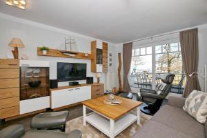 a living room with a couch and a table at Meeresblick Wohnung 104 - 4 Sterne DTV in Kühlungsborn