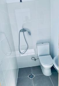 a white bathroom with a toilet and a shower at Sunset View in Arona
