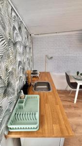 a kitchen with a wooden table with a sink at Sunset View in Arona