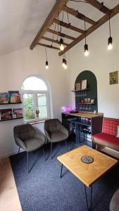 a living room with two chairs and a table at La Carte Postale in Oye-Plage