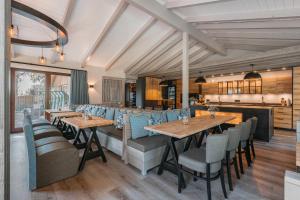 a restaurant with wooden tables and blue chairs at Ferienhof Brandt in Hedwigenkoog