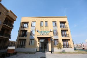 a building with a sign on the front of it at Sem Brand Hotel in Türkistan