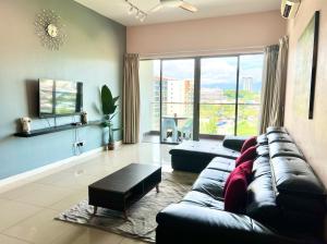 a living room with a couch and a large window at Imago Loft Residences - By The Pool in Kota Kinabalu