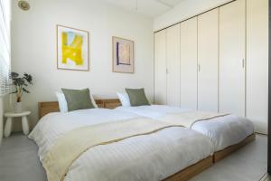 Ένα ή περισσότερα κρεβάτια σε δωμάτιο στο Cozy Stay Sapporo East 302