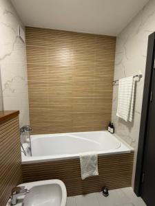 a bathroom with a large tub and a sink at Illi Home in Râmnicu Vâlcea +21 photos