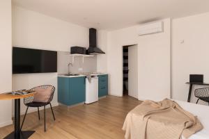 Televízia a/alebo spoločenská miestnosť v ubytovaní Apartamentos Líbere Valencia Abastos