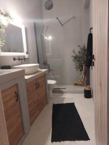 a bathroom with a sink and a toilet and a shower at Horizon View in Arnados in Tinos