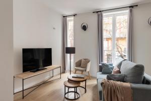 Televízia a/alebo spoločenská miestnosť v ubytovaní Apartamentos Líbere Valencia Abastos