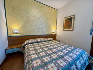a hotel room with a bed and a wall at Premium Apartments Peschiera in Peschiera del Garda +170 photos