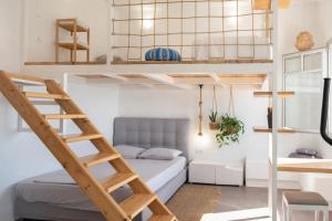 a room with a bunk bed and a ladder at Κατοικία Uppolis με θέα τα νησιά in Ano Syros +94 photos