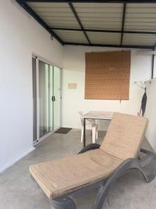 a table and a bench in a room at Santa Studio in La Gaulette