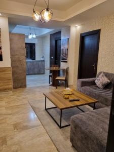 a living room with a couch and a table at unique 2bedroom at abdoun 001 in Amman +20 photos