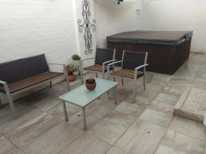a living room with two chairs and a bed at The Lookout, 195 Bester Street, Clarens in Clarens