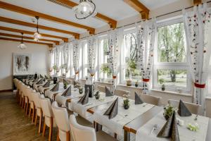 a row of tables in a room with windows at Kaiserhof Feldberg in Feldberg